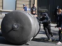 Protesters takes cover after police fired flee tear gas during a demonstration called by the "yellow vest" (gilets jaunes) movement on September 12, 2020 in Paris. Alain JOCARD / AFP