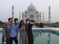 Tourists have their pictures taken at the Taj Mahal in Agra on September 21, 2020. The Taj Mahal reopened to visitors on September 21 in a symbolic business-as-usual gesture even as India looks set to overtake the US as the global leader in coronavirus infections. Sajjad HUSSAIN / AFP