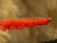 A Coulson 737 firefighting tanker jet drops fire retardant to slow Bobcat Fire at the top of a major run up a mountainside in the Angeles National Forest on September 10, 2020 north of Monrovia, California. California wildfires that have already incinerated a record 2.3 million acres this year and are expected to continue till December. The Bobcat Fire has grown to about 24,00 acres, and is 6% contained. David McNew/Getty Images/AFP DAVID MCNEW / GETTY IMAGES NORTH AMERICA / Getty Images via AFP
