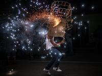 A member of the Afro-Mexican community carries a "toritol" of fire during the annual festival dedicated to San Nicolas Tolentino, in Cuajinicuilapa, Guerrero state, Mexico, on September 9, 2020, amid the COVID-19 coronavirus pandemic. Although there are 1,5 million African descendants in a country of 128 million inhabitants, it is normal to hear that "in Mexico there are no blacks". PEDRO PARDO / AFP