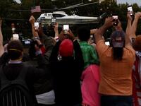 Supporters cheer as US President Donald Trump leaves Walter Reed Medical Center in Bethesda, Maryland on Marine One on October 5, 2020, to return to the White House after being discharged. Trump announced Monday he would be "back on the campaign trail soon", just before returning to the White House from a hospital where he was being treated for Covid-19. Olivier DOULIERY / AFP