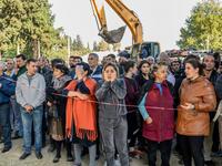 People stand behind caution tape as rescuers search for victims or survivors at the blast site hit by a rocket during the fighting between Armenia and Azerbaijan over the breakaway region of Nagorno-Karabakh, in the city of Ganja, Azerbaijan, on October 11, 2020. Bulent Kilic / AFP