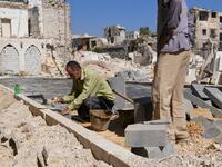 Syrian workers take part in the reconstruction of the Hatab Square in the Jdaideh neighbourhood in Aleppo's Old City on October 17, 2020. AFP