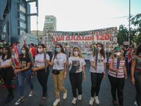 Lebanese protesters carry torches during a demonstration marking the one year anniversary of the beginning of a nationwide anti-government protest movement, in the capital Beirut on October 17, 2020. ANWAR AMRO / AFP