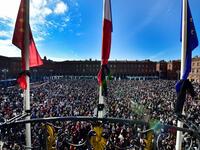 Flags of the City hall are at half-mast as people gather on Place du Capitole in Toulouse on October 18, 2020, in homage to history teacher Samuel Paty two days after he was beheaded by an attacker who was shot dead by policemen. GEORGES GOBET / AFP
