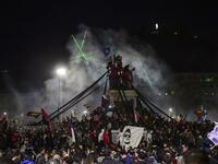 Demonstrators supporting the reform of the Chilean constitution celebrate while waiting for the referendum official results at Plaza Italia in Santiago on October 25, 2020. Chile's President Sebastian Pinera called on the nation to work together for a "new constitution" after Chileans voted overwhelmingly to replace their dictatorship-era charter. MARTIN BERNETTI / AFP