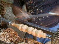 A carpenter shaves a piece of wood to make a narguileh (water pipe) at his workshop in Iraq's central holy city of Karbala on October 21, 2020. The business of strictly gender-separated cafes has carried on, despite the heavy health risks associated with smoking and a full-blown pandemic that has brought an average of 4,000 new coronavirus cases a day to Iraq. Mohammed SAWAF / AFP
