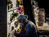 A woman wearing a face mask disinfects her hands at the Alto de Sao Joao cemetery in Lisbon on October 30, 2020 on the eve of All Saints' Day amid the coronavirus pandemic. PATRICIA DE MELO MOREIRA / AFP