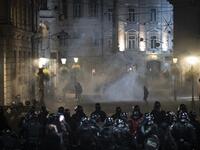 Protesters run through tear gas as they clash with police during the rally against government’s coronavirus restrictions in Ljubljana on November 5, 2020. Jure Makovec / AFP