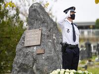 A member of the French national police stands to attention as he take part in a ceremony for the French soldiers of the Front d'Orient (1915-1918) who died in Kosovo, at the Military square in Pristina on November 11, 2020, during the Armistice Day commemorations marking the 102nd anniversary of the end of WWI (World War One). Armend NIMANI / AFP