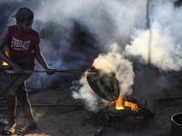 In this picture taken on November 12, 2020 dockyard workers carries maintenance works on the banks of the Buriganga river in Char Kaliganj on the outskirts of Dhaka. Rivers are the lifeblood of the delta nation of 168 million people where much of the low-lying land is accessed via boat, with Bangladesh's strong economic growth of recent years fuelling more investments in new and bigger ships. Munir UZ ZAMAN / AFP