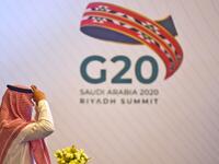 A Saudi man adjusts his head cover ahead of a meeting of Finance ministers and central bank governors of the G20 nations in the Saudi capital Riyadh on November 18, 2020. Saudi Arabia hosts the G20 summit Saturday in a first for an Arab nation, but the scaled-down virtual format could limit debate on a resurgent coronavirus pandemic and crippling economic crisis. FAYEZ NURELDINE / AFP 