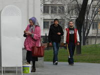 An elderly woman lights candles outside  the Temple of Saint Sava in Belgrade, Serbia /Photo by Ewelina Lepionko