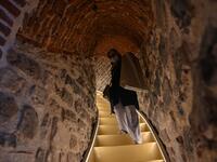 A woman walks upstairs after the restoration of the Galata Tower on October 16, 2020 in Istanbul. The Galata Tower -- an emblematic 14th century monument of Istanbul -- has become the latest victim of such controversy. Ozan KOSE / AFP