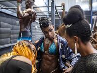 Bodybuilders gather in the backstage warming up area before taking aprt in the Iron Fit Bodybuilding competition in Nairobi on December 05, 2020. 130 participants from all across East Africa took part in the second edition of this competition which included categories like Bikini, Figure, Physique and Bodybuilding. Patrick Meinhardt / AFP