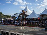 A bodybuilder poses on stage during the Iron Fit Bodybuilding competition in Nairobi on December 05, 2020. 130 participants from all across East Africa took part in the second edition of this competition which included categories like Bikini, Figure, Physique and Bodybuilding. Patrick Meinhardt / AFP