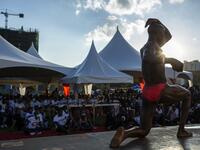 A bodybuilder poses on stage as he takes part in the Iron Fit Bodybuilding competition in Nairobi on December 05, 2020. 130 participants from all across East Africa took part in the second edition of this competition which included categories like Bikini, Figure, Physique and Bodybuilding. Patrick Meinhardt / AFP