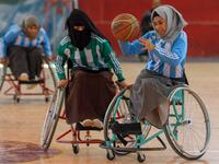 Disabled Yemeni women take part in a local wheelchair basketball championship in Yemen's capital Sanaa on December 8, 2020. In conflict-ridden Yemen, nine teams, including five-all women groups, competed in a local championship for the disabled in the capital Sanaa, which has been under rebel control since 2014. The players are competing to be embraced by society for their strengths rather than be viewed as a burden during the time of war. Mohammed HUWAIS / AFP