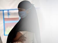 This photo taken on October 21, 2020 shows Rohingya refugee Janu, 18, whose family had arranged to marry a Rohingya man working as a labourer in Malaysia, at a temporary shelter in Lhokseumawe, Indonesia's Aceh province. Stay in a squalid refugee camp -- hopeless, starving, and made to feel a burden -- or leave, risking death, rape, human trafficking and months at sea to reach a husband you've never met. This is the bleak choice many Rohingya women, already scarred from fleeing persecution in Myanmar, are n