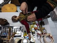 Augusto Grilli repairs a puppet in his " Alfa Theatre" laboratory in Turin, on November 30, 2020. The Grilli family has a collection of more than 20,000 objects from around the world, everything from theatres, marionettes and glove puppets to shadow figures and silhouettes. A long-time dream of Grilli and his wife Mariarosa, 78, the museum is due to open in 2023 in Turin, financed both privately and publicly with the help of different institutions.  Marco Bertorello / AFP