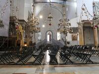 Empty chairs are pictured during Sunday mass in the Church of the Nativity, in the West Bank city of Bethlehem, on December 20, 2020 after it was re-opened for prayers following strict COVID-19 restrictions. HAZEM BADER / AFP