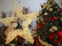 A Palestinian shop-owner arranges Christmas decorations at her shop in the West Bank city of Bethlehem on December 21, 2020. HAZEM BADER / AFP