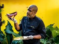 Ralph Leroy, chocolate maker, entrepreneur and chocolate sculptor, poses with one of his emblematic creations, a shoe in the workshops of Makaya Chocolat on December 23, 2020 in Petionville, Haiti. Although small in the face of South America's giants, Haiti is slowly developing its cocoa industry to ensure better incomes for thousands of modest farmers and to end the stereotype of gastronomic art known as the domain of wealthy countries. Valerie Baeriswyl / AFP