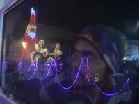 A car driver looks at a model of Santa Claus illuminated, on the eve of Christmas in Siliguri on December 24, 2020. DIPTENDU DUTTA / AFP