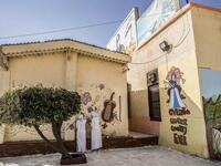 This picture taken during a government-guided tour on December 27, 2020 shows inmates drawing a mural on a wall at al-Qanatir women's prison, at the tip of the Nile delta in Qalyoubiya province, about 30 kilometres north of Egypt's capital. Khaled DESOUKI / AFP