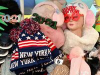 Souvenirs are seen at a stand at Times Square ahead of New Year's Eve celebrations on December 28, 2020 in New York City. - The pandemic has caused long-term repercussions throughout the tourism and entertainment industries, including temporary and permanent closures of historic and iconic venues, costing the city and businesses billions in revenue. Angela Weiss / AFP