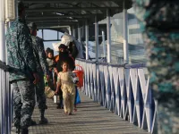 Rohingya refugees embark on a Bangladesh Navy ship as they are relocated to the controversial flood-prone island Bhashan Char in the Bay of Bengal, in Chittagong on December 29, 2020. Rehman ASAD / AFP