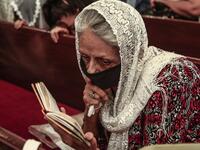 A Sudanese Copticwoman attends Christmas midnight mass at the capital Khartoum's Martyrs Church late on January 6, 2021, as the Orthodox Christian faith uses the old Julian calendar in which Christmas falls 13 days after the date in the more widespread Gregorian calendar.  Ebrahim HAMID / AFP