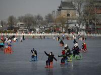 People use sleds on a frozen lake in Beijing on January 12, 2021. WANG Zhao / AFP