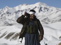 In this photo taken on January 9, 2021, a Hazara armed militia for the Resistance for Justice Movement, walks along the road during a patrol against Taliban insurgents at Hisa-e-Awali Behsud district of Maidan Wardak Province. Comprising roughly 10 to 20 percent of Afghanistan's 38-million population, Hazaras have long been persecuted for their largely Shiite faith by Sunni hardliners in a country wracked by deep ethnic divisions. WAKIL KOHSAR / AFP