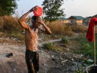 This photo taken on January 11, 2021 shows a Chin man washing in Bethel village in Hmawbi, on the outskirts of Yangon, where hundreds of members of the Chin ethnic community have settled after being displaced by fighting between Myanmar's military and the Arakan Army in the country's north.  Ye Aung THU / AFP