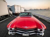 This picture taken on January 16, 2021 shows Hiroyuki Wada, who runs a vintage car service company, sitting in a 1959 Cadillac Coupe DeVille after a gathering of auto enthusiasts in Tokyo. A loose club of fans rolls up most weekends in central Tokyo to show off their Cadillacs, Chevrolets and other modern classic vehicles from the mid to late 20th century. Philip FONG / AFP