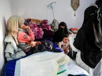 Al-Anoud Hussain Sheryan (L), a 19-year-old girl disfigured in an acid attack by her abusive husband, sits at a hospital where she is undergoing treatment in Yemen's capital Sanaa on January 28, 2021. Married at the age of 12, rejected at 16, and then disfigured in an acid attack, Sheryan's fate is a shocking illustration of abuse in a society beset by war and poverty. Now aged 19, the young Yemeni woman agreed to relate her ordeal at the hands of her abusive husband -- rare testimony in a country where dom
