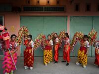 This photograph taken on January 20, 2021 shows Le Yen Quyen (L) practising a dragon dance routine along with other female dancers at the Tu Anh Duong lion and dragon dance school in Can Tho city in southern Vietnam's Mekong Delta. Manan VATSYAYANA / AFP