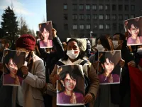 A group of Myanmar activists hold the portrait of Aung San Suu Kyi during a protest outside the United Nation university in Tokyo on February 1, 2021 following a military coup in the country by a general after arresting civilian leader Aung San Suu Kyi and other senior officials. Philip FONG / AFP