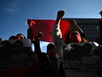 A group pf Myanmar activists chant slogans during a protest outside the United Nations university building in Tokyo on February 1, 2021 following a military coup in the country by a general after arresting civilian leader Aung San Suu Kyi and other senior officials. Philip FONG / AFP