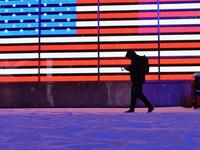A person walks in the snow at Times Square during a winter storm on February 1, 2021 in New York City. A powerful winter storm is set to dump feet of snow along a stretch of the US east coast including New York City on February 1, 2021, after blanketing the nation's capital. Angela Weiss / AFP
