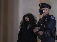 The family of late US Capitol Police officer Brian Sicknick, watch as his remains are carried up the steps of the Capitol in Washington, DC February 2, 2021. US President Joe Biden paid his respects Tuesday at a solemn memorial to the policeman killed last month during an attack on the Capitol by Donald Trump's supporters.  Tasos Katopodis / POOL / AFP