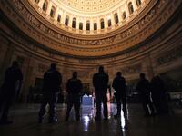 Capitol Police Officers pay their respects to late US Capitol Police officer Brian Sicknick as he lies in honor in the US Capitol Rotunda in Washington, February 2, 2021. US President Joe Biden paid his respects Tuesday at a solemn memorial to the policeman killed last month during an attack on the Capitol by Donald Trump's supporters.  LEAH MILLIS / POOL / AFP