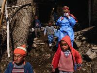 In this photograph taken on February 15, 2021, nurse Yildiz Ayten (rear R) from Bahcesaray public hospital vaccination team is escorted by Kurdish children as she searches for old people at the village of Guneyyamac in eastern Turkey, as part of an expedition to vaccinate residents of 65 years old or above with Sinovac's CoronaVac Covid-19 vaccine. Turkey's population of more than 83 million is spread out across Europe and Asia and covers some seemingly impregnable terrain. The vaccination effort with China