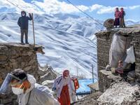 In this photograph taken on February 15, 2021, doctor Sergen Saracoglu (L) and nurse Yilzdiz Ayten (C) from the Bahcesaray public hospital vaccination team, arrive at the village of Guneyyamac in eastern Turkey, as part of an expedition to vaccinate residents of 65 years old or above with Sinovac's CoronaVac Covid-19 vaccine. Turkey's population of more than 83 million is spread out across Europe and Asia and covers some seemingly impregnable terrain. The vaccination effort with China's CoronaVac jab kicked