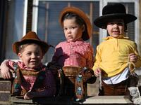 Young children dressed in costume in celebration of the Jewish holiday of Purim, pose for a photograph outside a house in the Orthodox Jewish neighborhood of Stamford Hill in north London on February 26, 2021. The carnival-like Purim holiday is celebrated with parades and costume parties to commemorate the deliverance of the Jewish people from a plot to exterminate them in the ancient Persian Empire 2,500 years ago, as recorded in the Biblical Book of Esther. DANIEL LEAL-OLIVAS / AFP