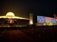 A screen of attendees, appearing via video conferencing, due to the Covid-19 coronavirus pandemic, is displayed during Makha Bucha celebrations at Wat Dhammakaya, north of Bangkok on February 26, 2021. Jack TAYLOR / AFP