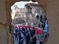 Iraqis gather near the ruins of the Syriac Catholic Church 