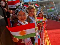 Irqi children wave Kurdish flags as they welcome Pope Francis 