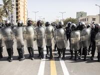 Police officers take their positions during a protest in Dakar on March 8, 2021, after the country's opposition leader Ousmane Sonko was charged with rape. Usually considered a beacon of stability in a volatile region, deadly clashes between opposition supporters and security forces have rocked the West African state. JOHN WESSELS / AFP